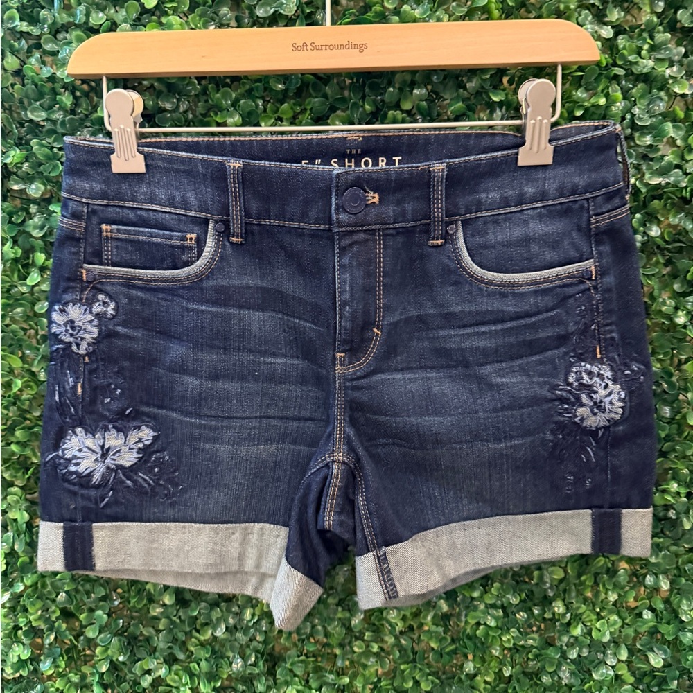 White House Black Market denim shorts with embroidered floral accents.